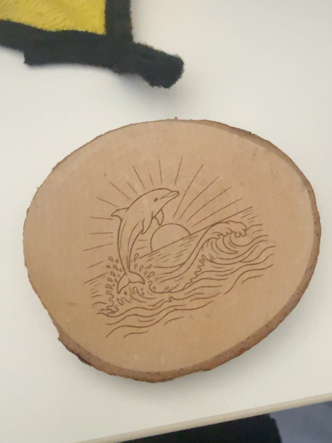 Dolphin engraved natural wood round