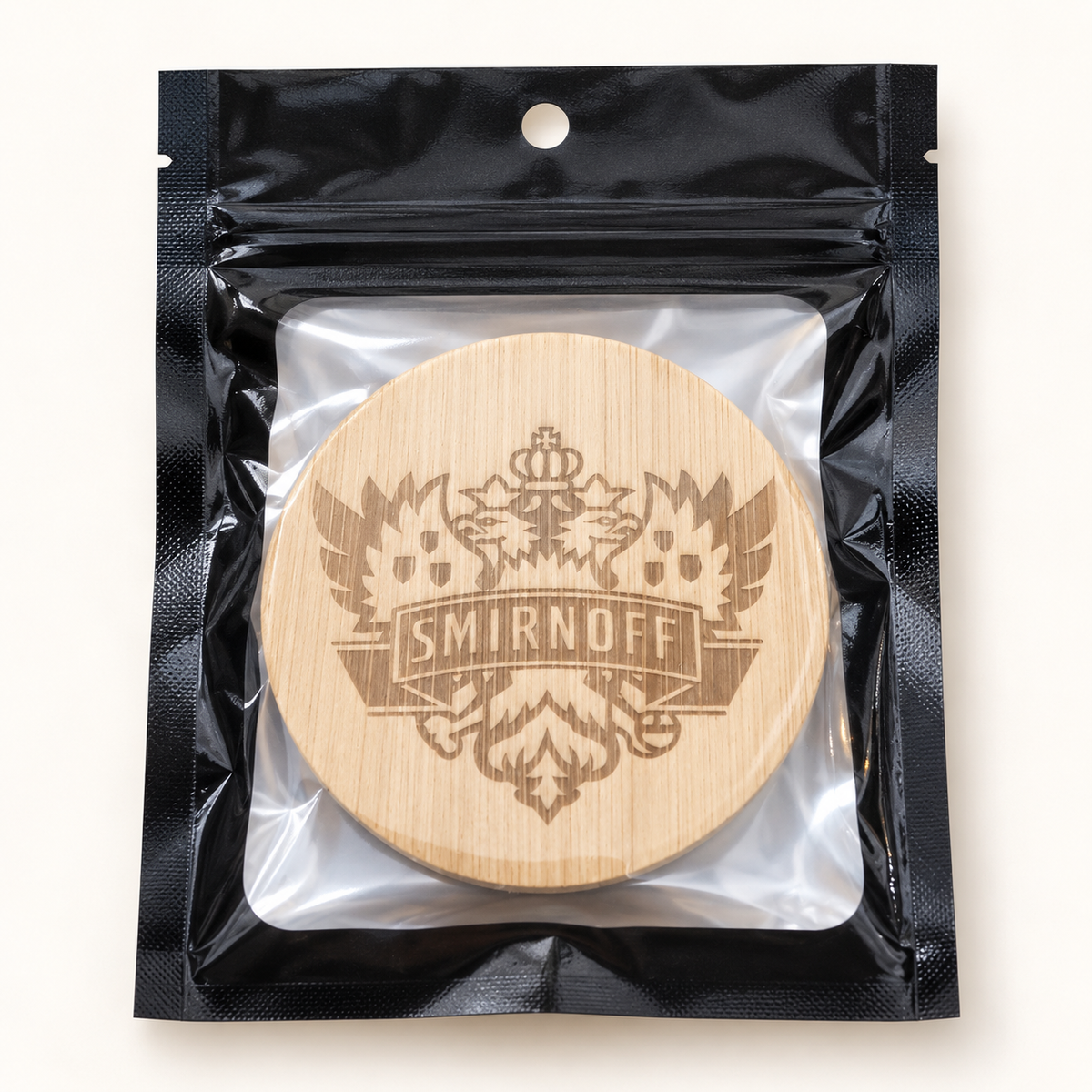 Smirnoff engraved wooden bottle opener in retail pouch on clean background